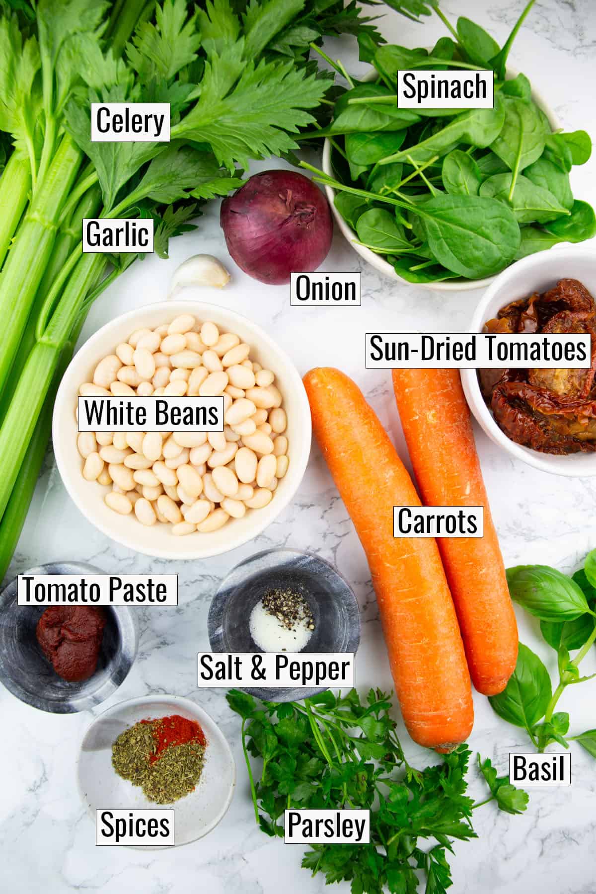 the ingredients that go into this recipe on a marble countertop with labels of each name
